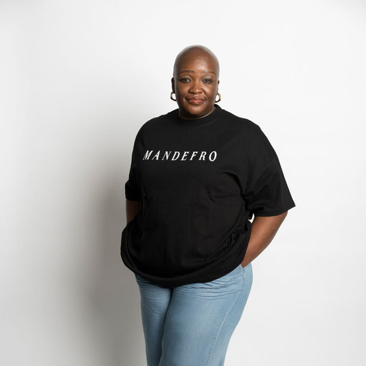 Woman wearing a black t-shirt with 'MANDEFRO' text on a white background