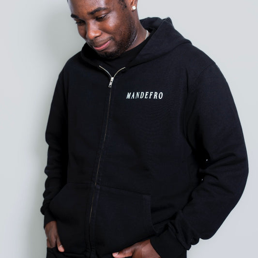 Person wearing a unisex black hoodie with 'MANDEFRO' branding on a plain background